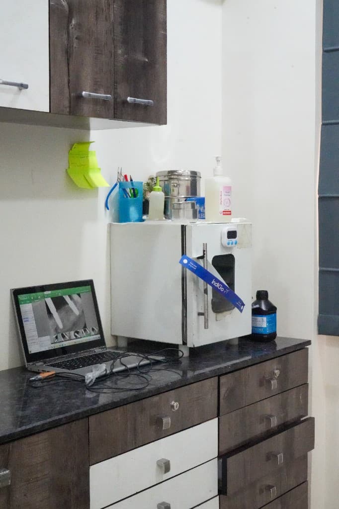 Laptop displaying digital dental X-ray and sterilization equipment at Oracare Dental Pune
